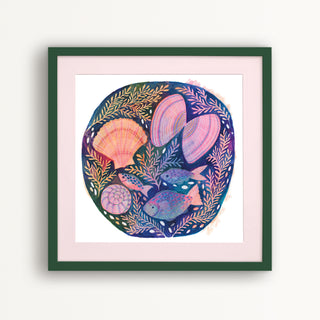 Print of an original painting by Lee Foster-Wilson of fish and shells displayed in a dark green frame with a pale pink mount